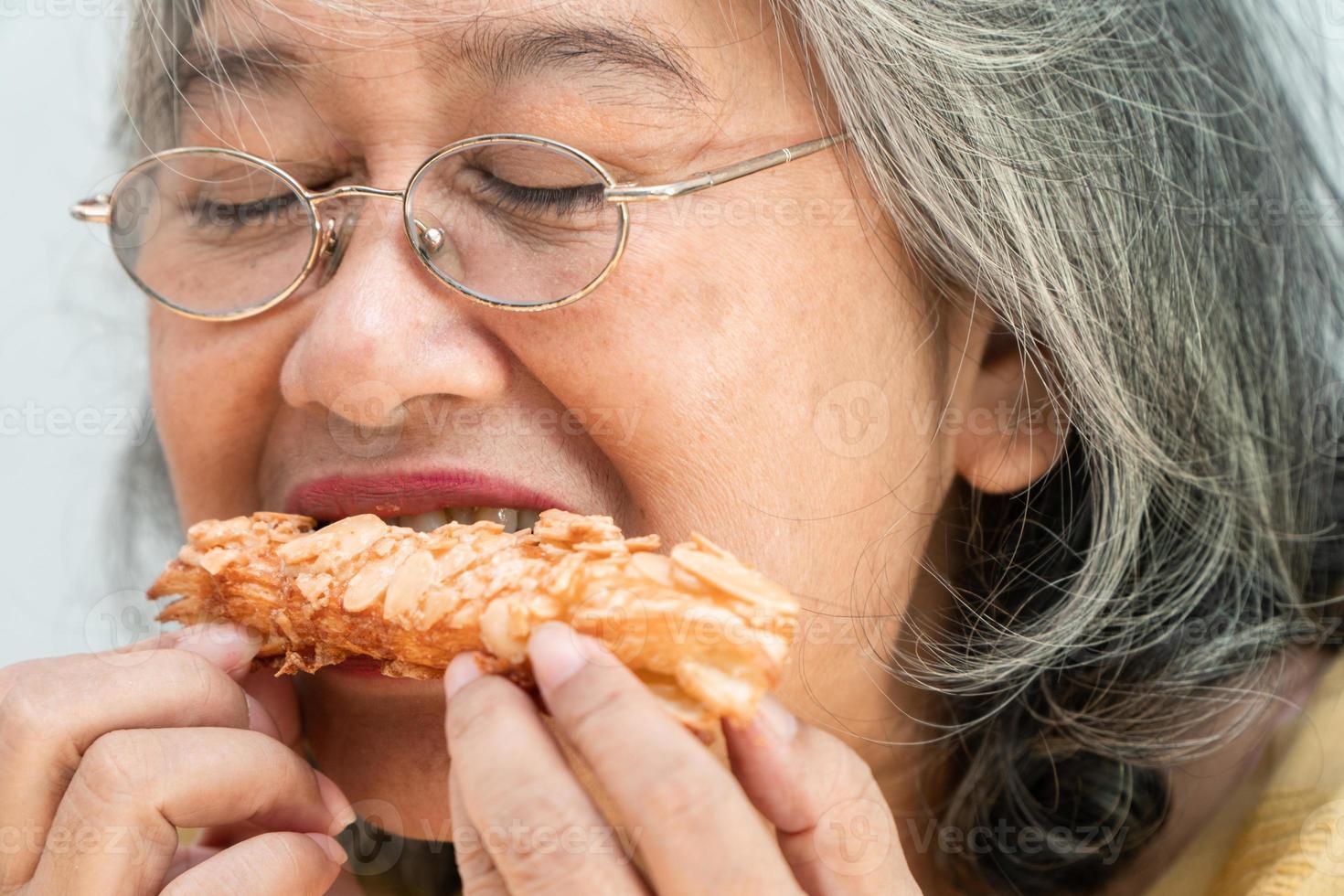 Happy Asian senior women enjoying eating pie photo