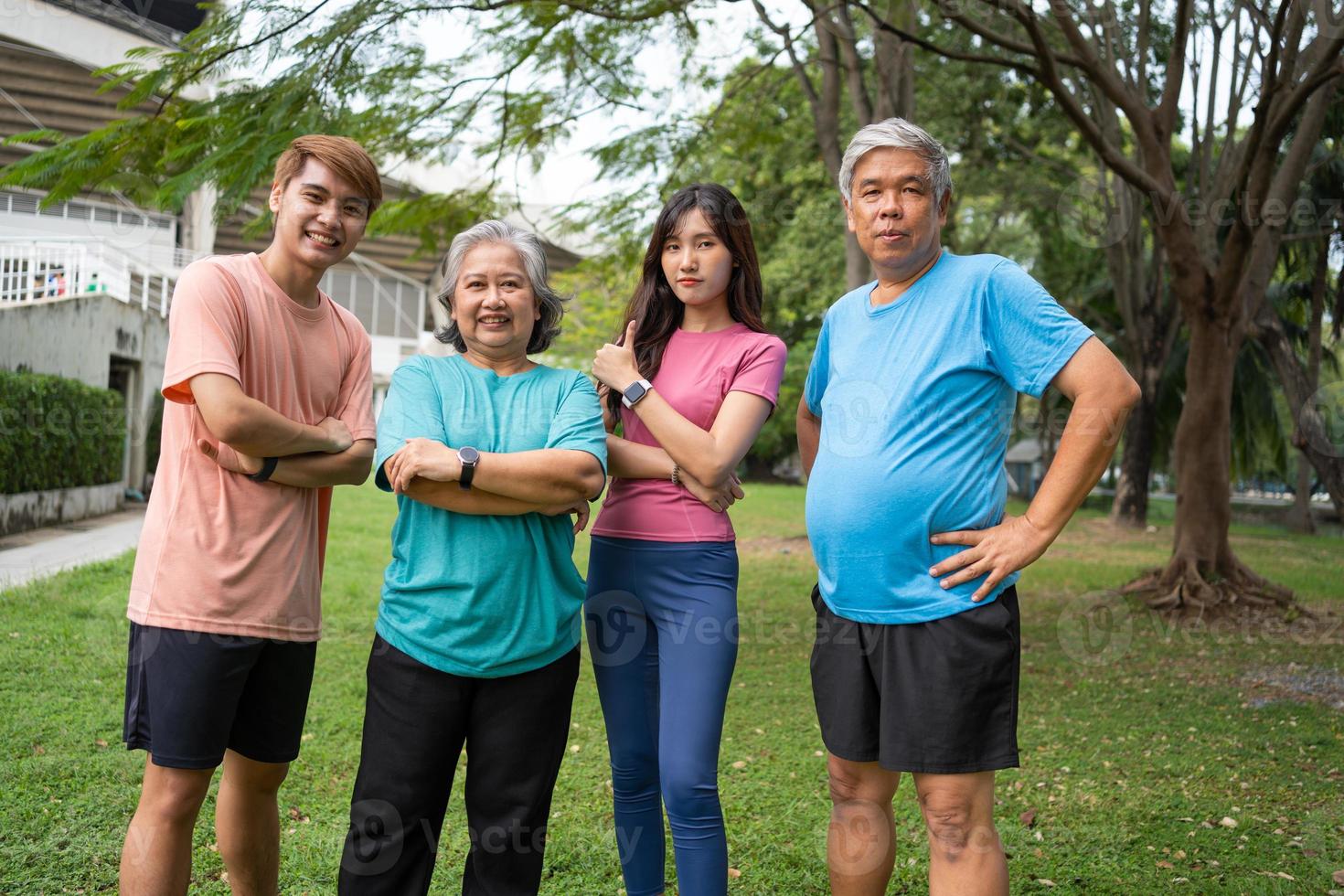 Healthy family group instructors workout in fresh air, and they rest and stand together after morning exercises in park. Outdoor activities, healthy lifestyle, strong bodies, fit figures, health care. photo
