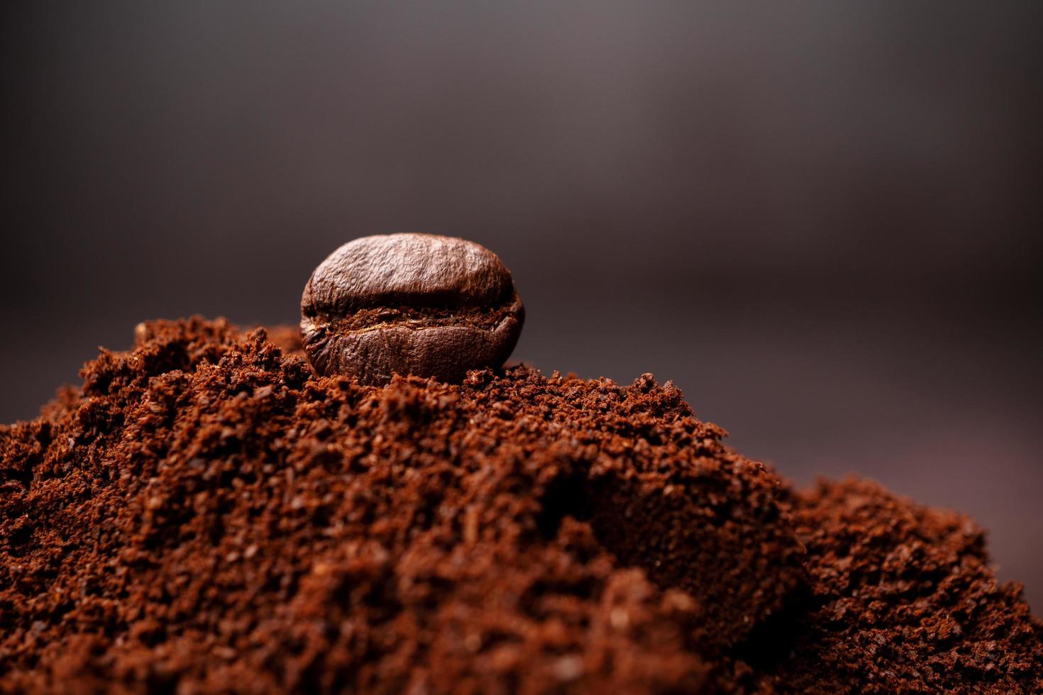 Closeup of coffee beans at the mixed heap of roasted coffee with copy space for text. Concept of Coffee freshness photo