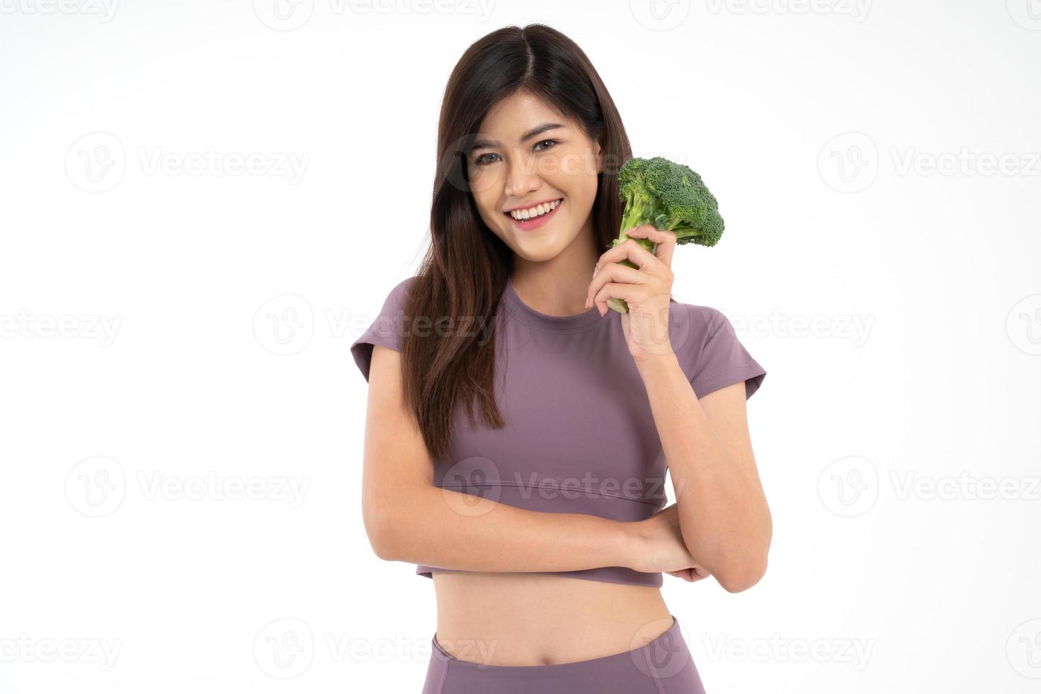 Portrait of young happy and healthy Asian woman holding Block Curry and looking at camera on white Isolated background. Concept of vegetarian diet, healthy lifestyle with healthy food. photo