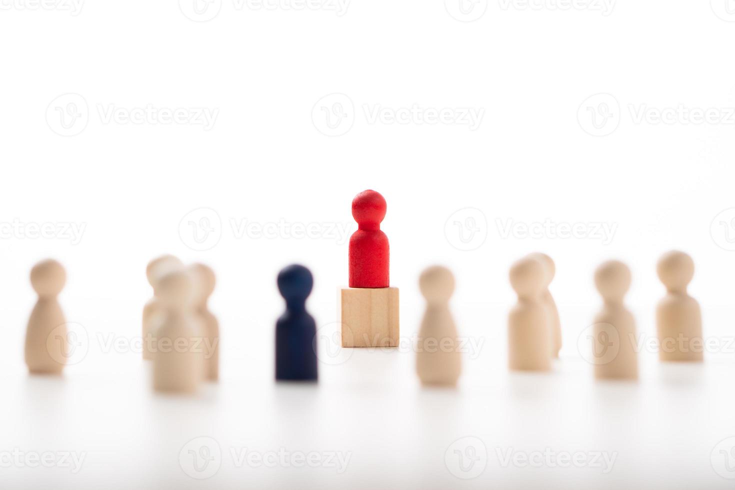 The red wooden figure standing on the box show influence and empowerment. Concept of business leadership for leader team, successful competition winner and Leader with influence photo