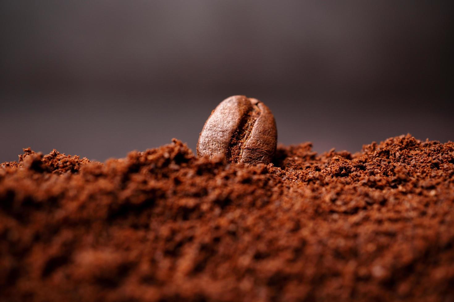 Closeup of coffee beans at the mixed heap of roasted coffee with copy space for text. Concept of Coffee freshness photo