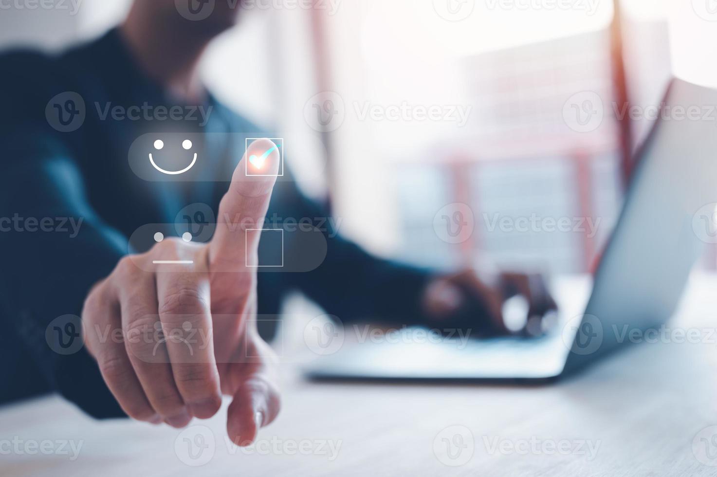 rating feedback and Customer service satisfaction survey concept.Business people or customers show satisfaction by pressing face emoticon smile in satisfaction on virtual touch screen. photo