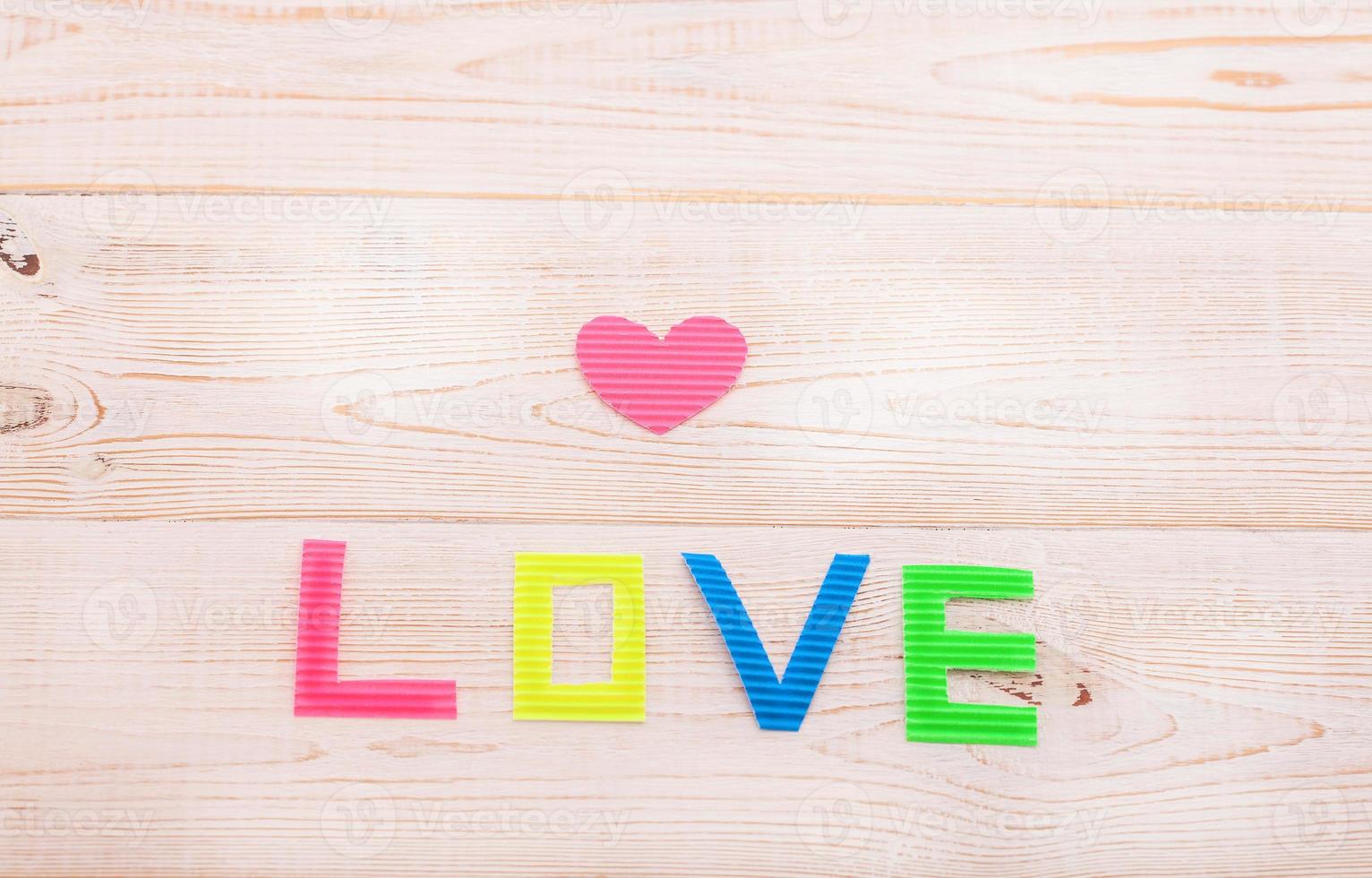 Word love on blue wooden background. Top view photo