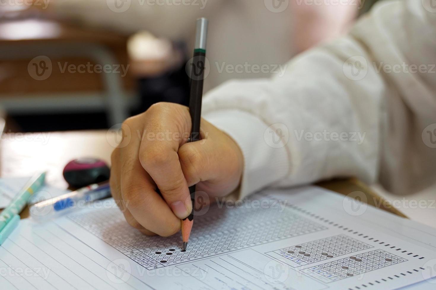 Thai students take a knowledge test to assess knowledge skills. The result of the exam will come out as a score value. Allows us to analyze the results or grade. Soft and selective focus. photo