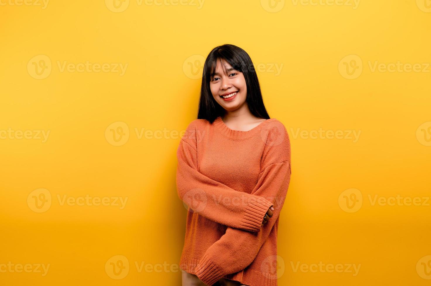 Cute Asian girl smiling on yellow background. Empty, young woman. Place for advertisement. copy space photo