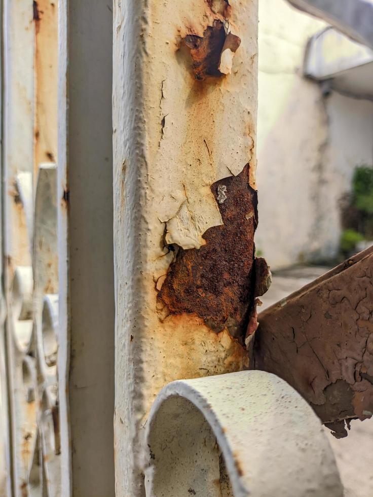 a close up of rusty white iron railings photo