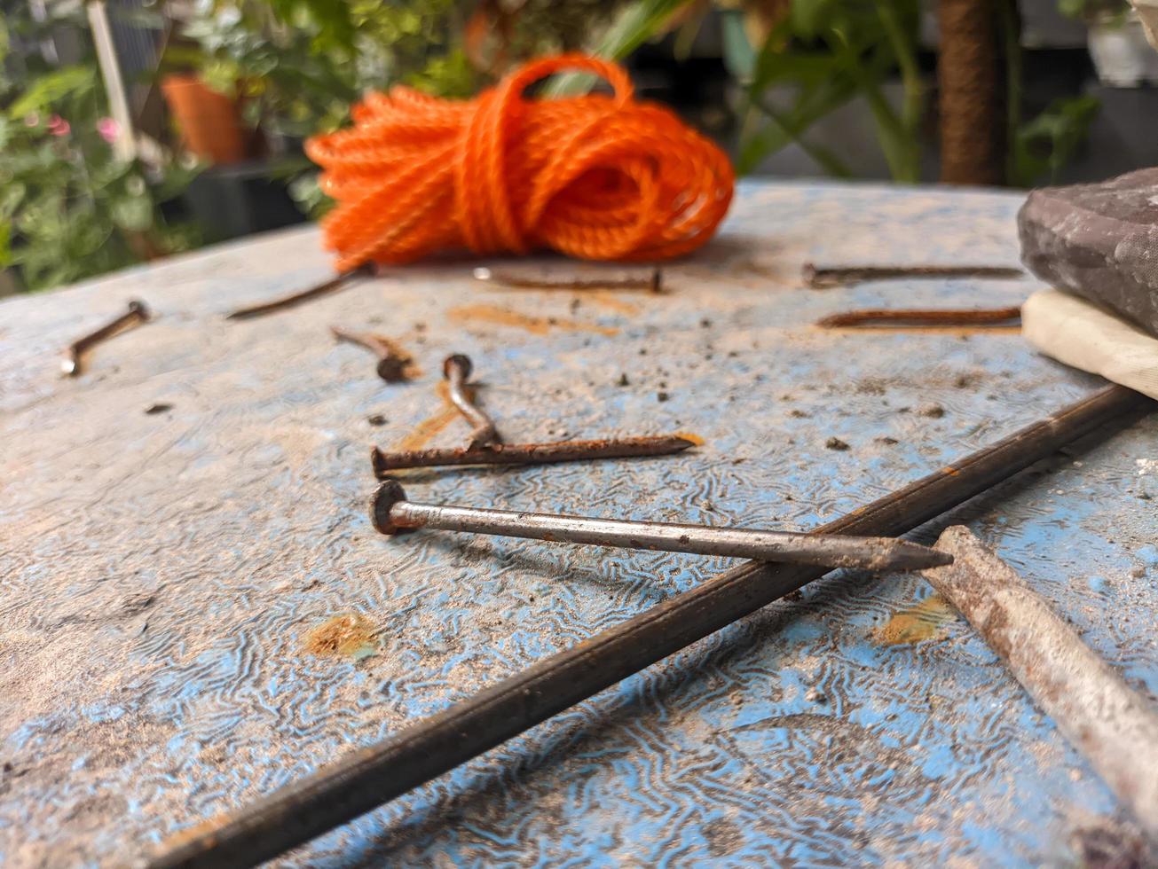 a close up of some iron nails on a blue table photo