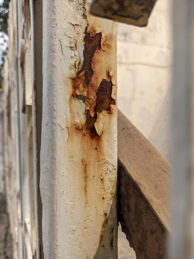 a close up of rusty white iron railings photo