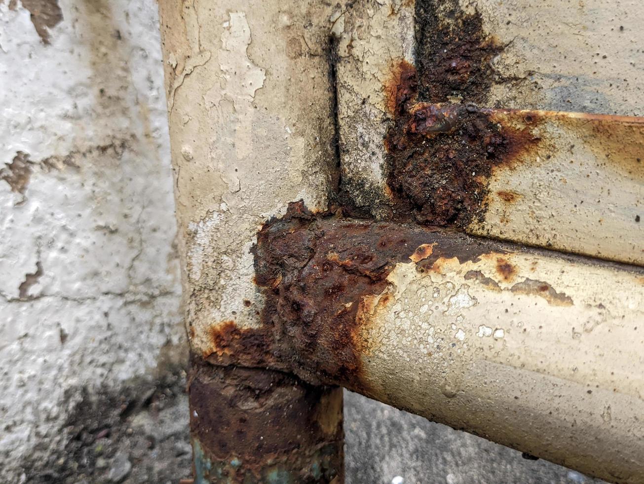 a close up of rusty white iron railings photo