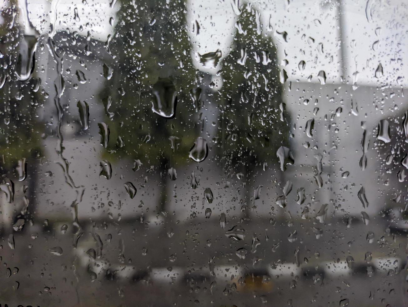 a raindrops dripping down the windshield of the car. For raindrops background. No people photo