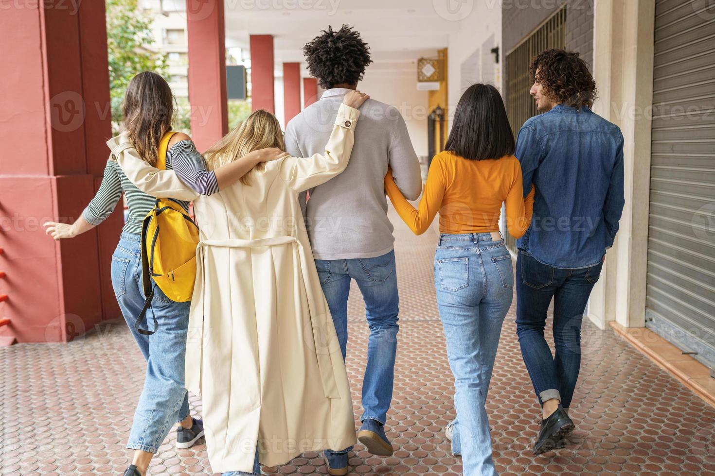 Company of diverse friends waking in city together photo