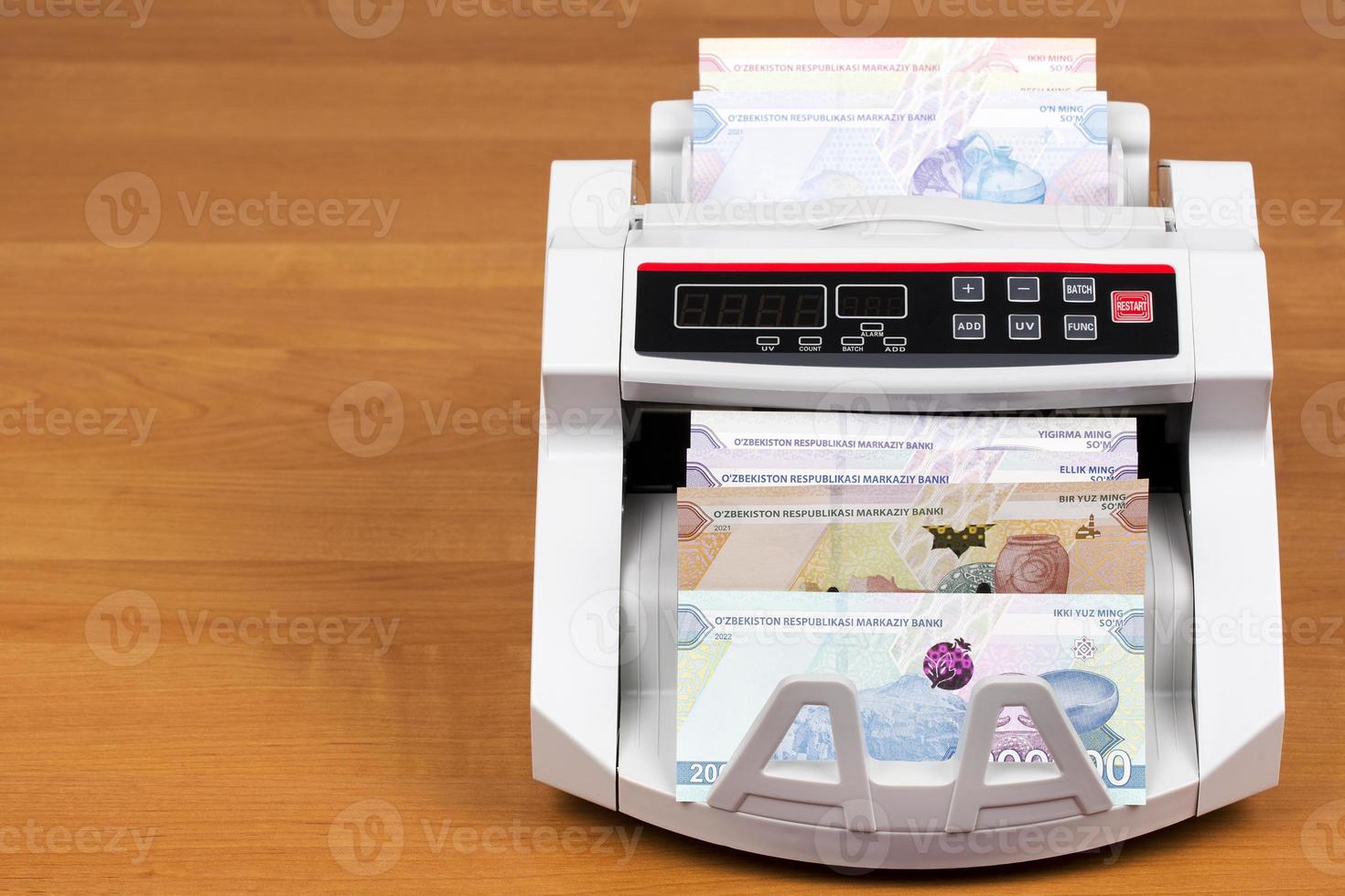 Uzbekistani money in the counting machine photo