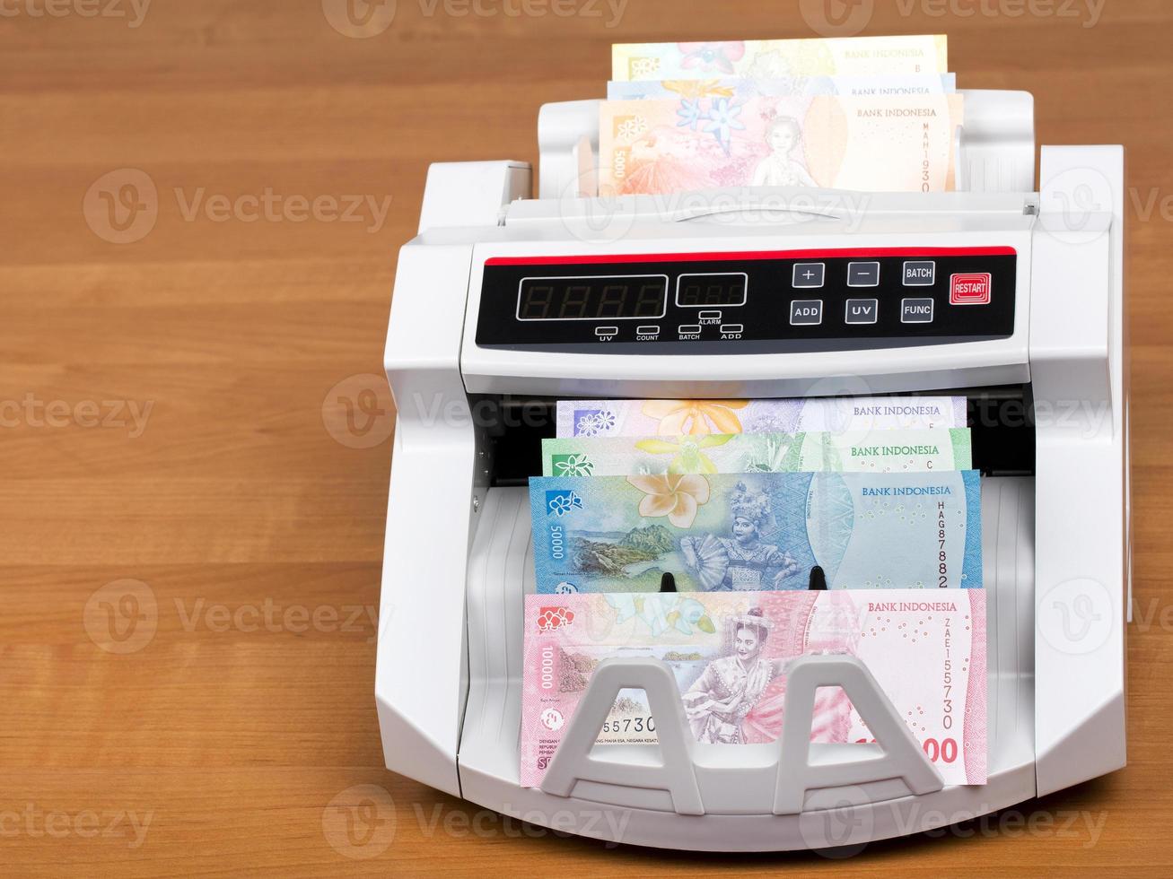 Indonesian money in a counting machine photo