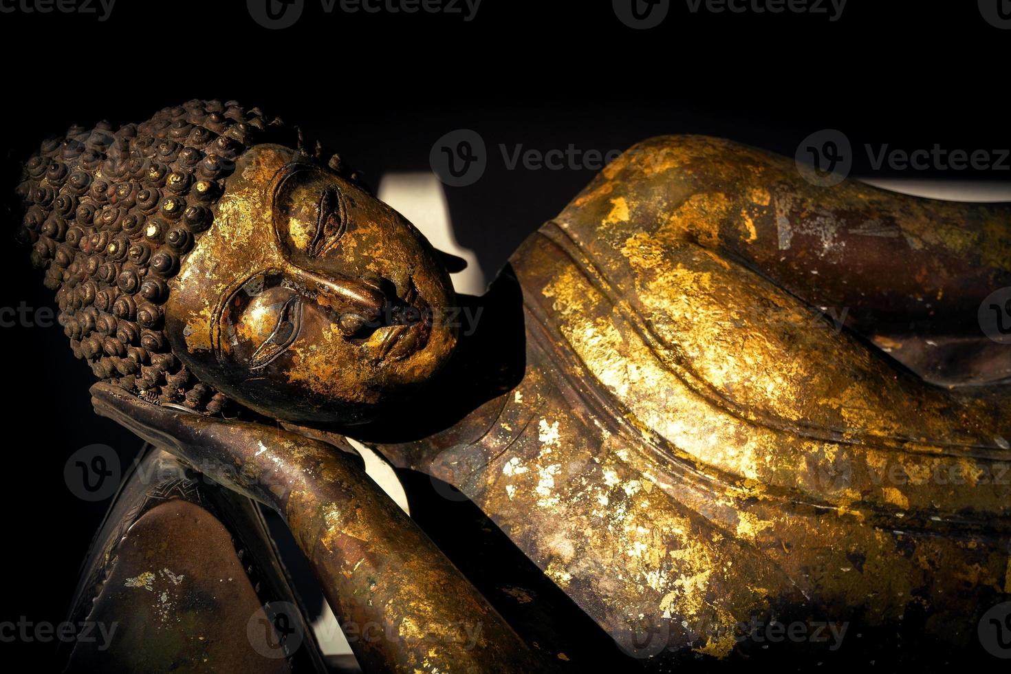 Ancient golden reclining buddha at the buddha temple,thailand photo