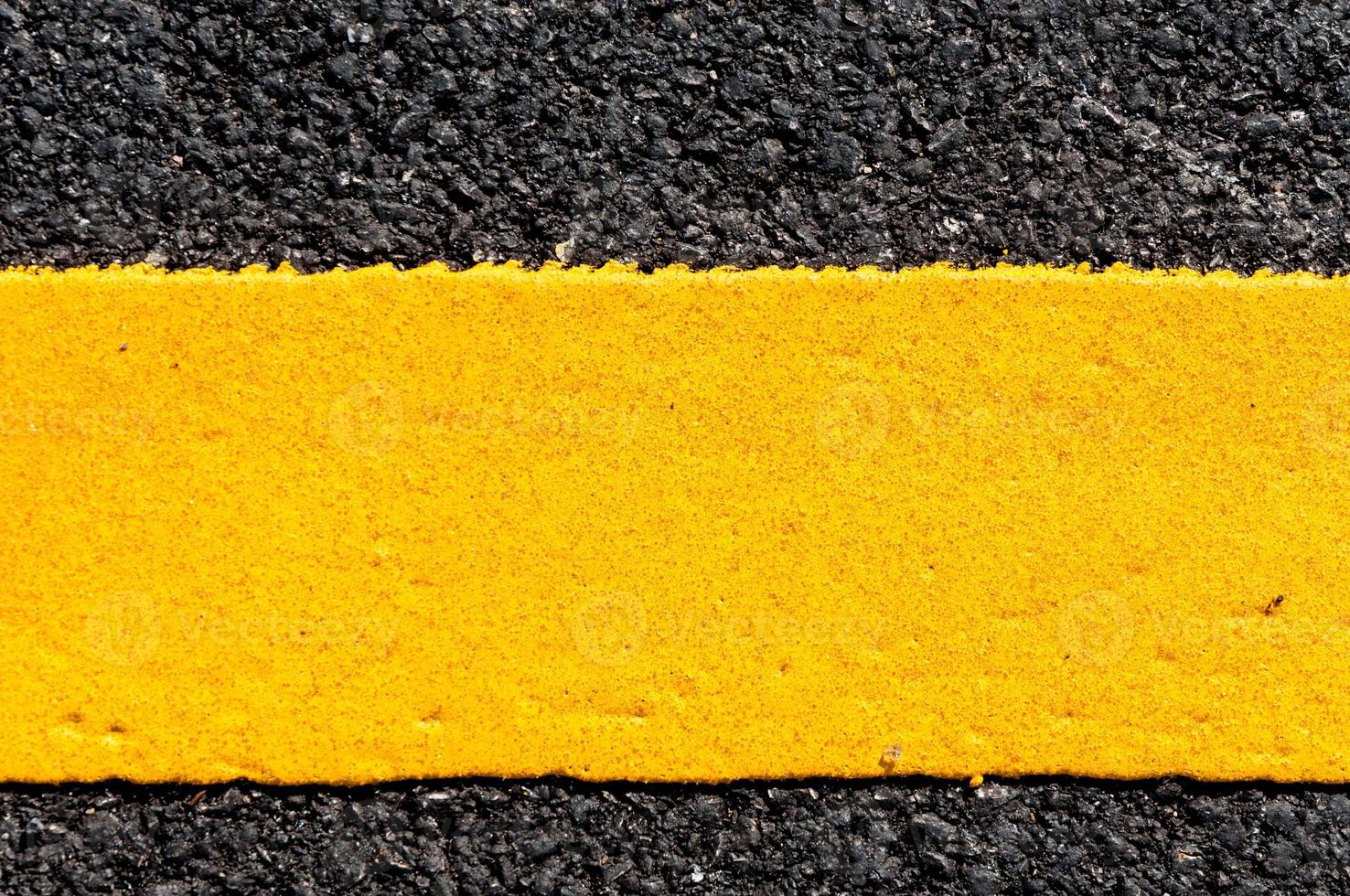 Yellow line on new asphalt detail,Street with yellow line texture photo