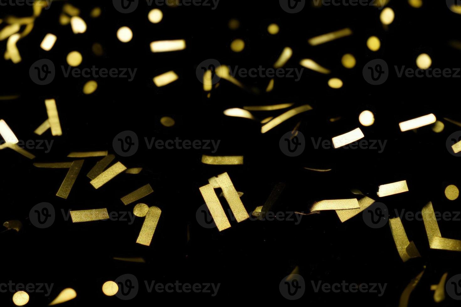 gold confetti on black background photo