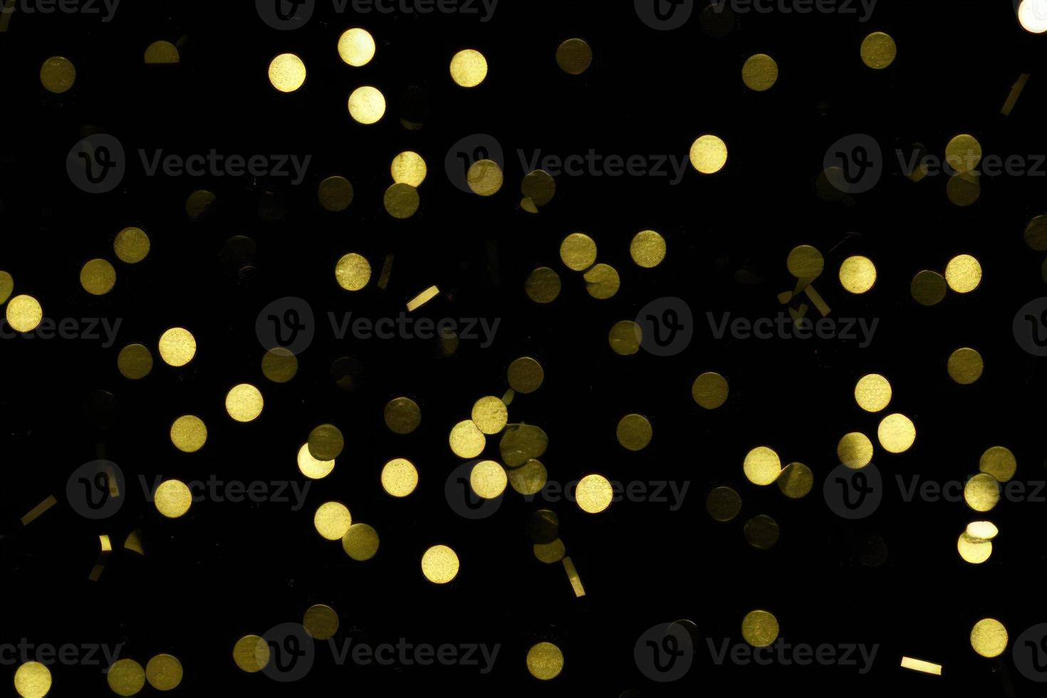 gold confetti on black background photo
