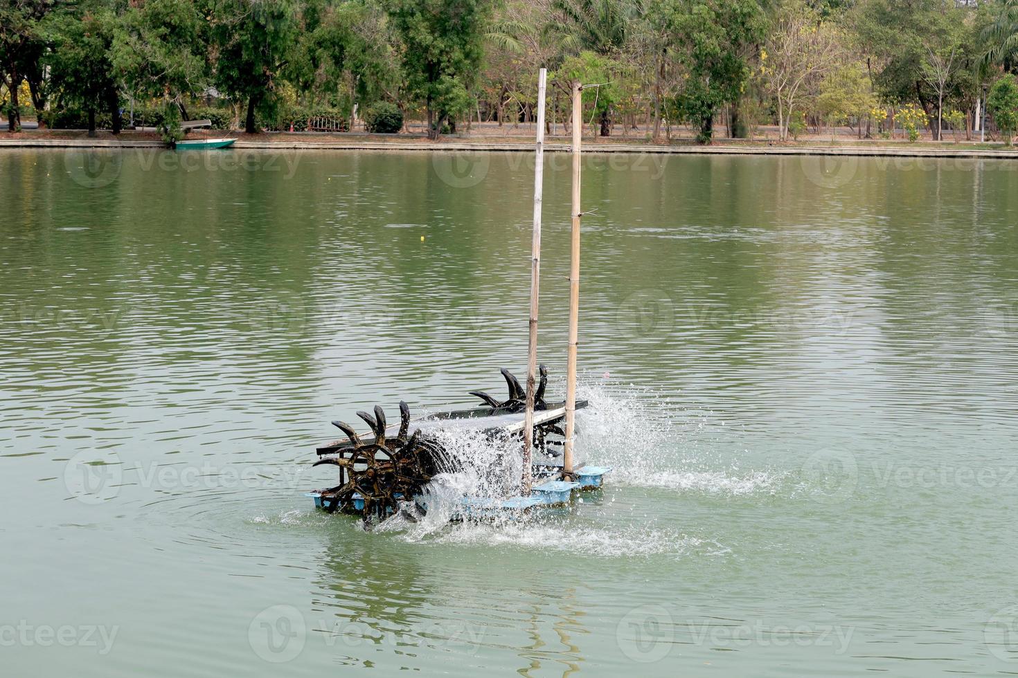 Water turbine in the dirty pond at the public park,Bangkok,Thailand,Asia photo