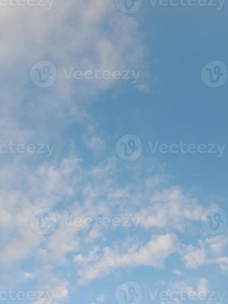 Beautiful white clouds on deep blue sky background. Large bright soft fluffy clouds are cover the entire blue sky. photo