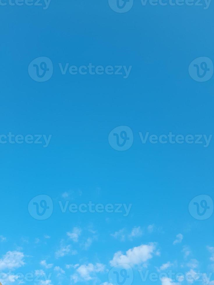 Beautiful white clouds on deep blue sky background. Large bright soft fluffy clouds are cover the entire blue sky. photo