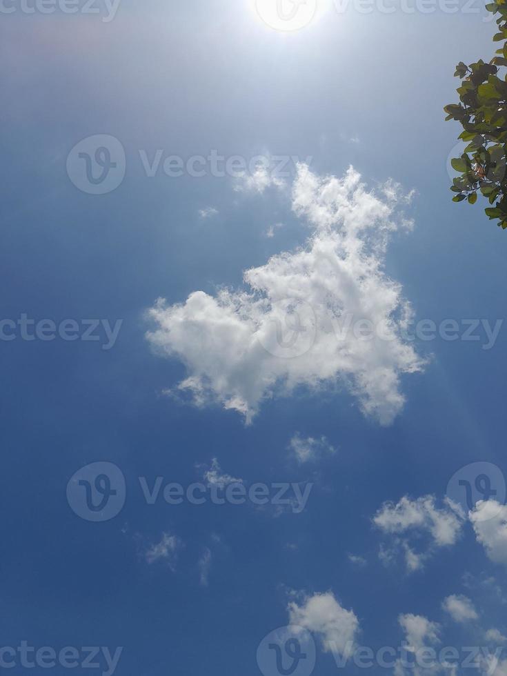 Beautiful white clouds on deep blue sky background. Large bright soft fluffy clouds are cover the entire blue sky. photo