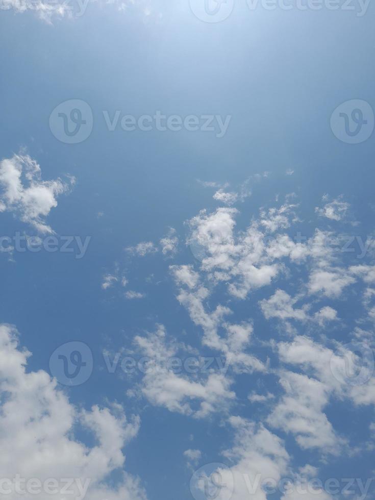 Beautiful white clouds on deep blue sky background. Large bright soft fluffy clouds are cover the entire blue sky. photo