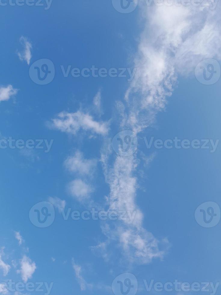 Beautiful white clouds on deep blue sky background. Large bright soft fluffy clouds are cover the entire blue sky. photo