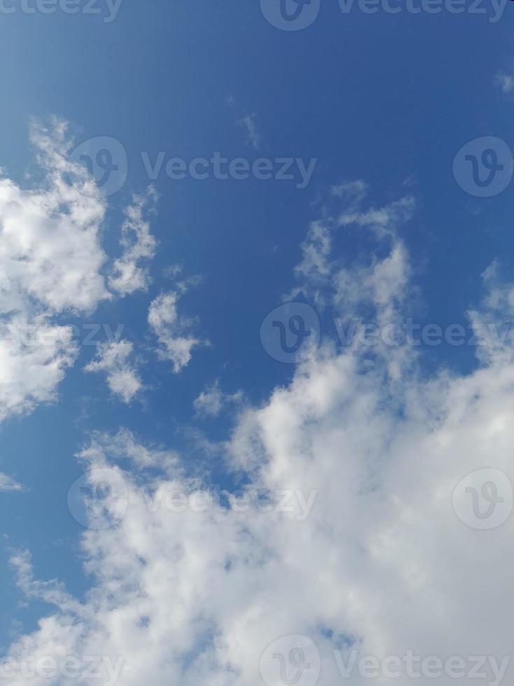 Beautiful white clouds on deep blue sky background. Large bright soft fluffy clouds are cover the entire blue sky. photo