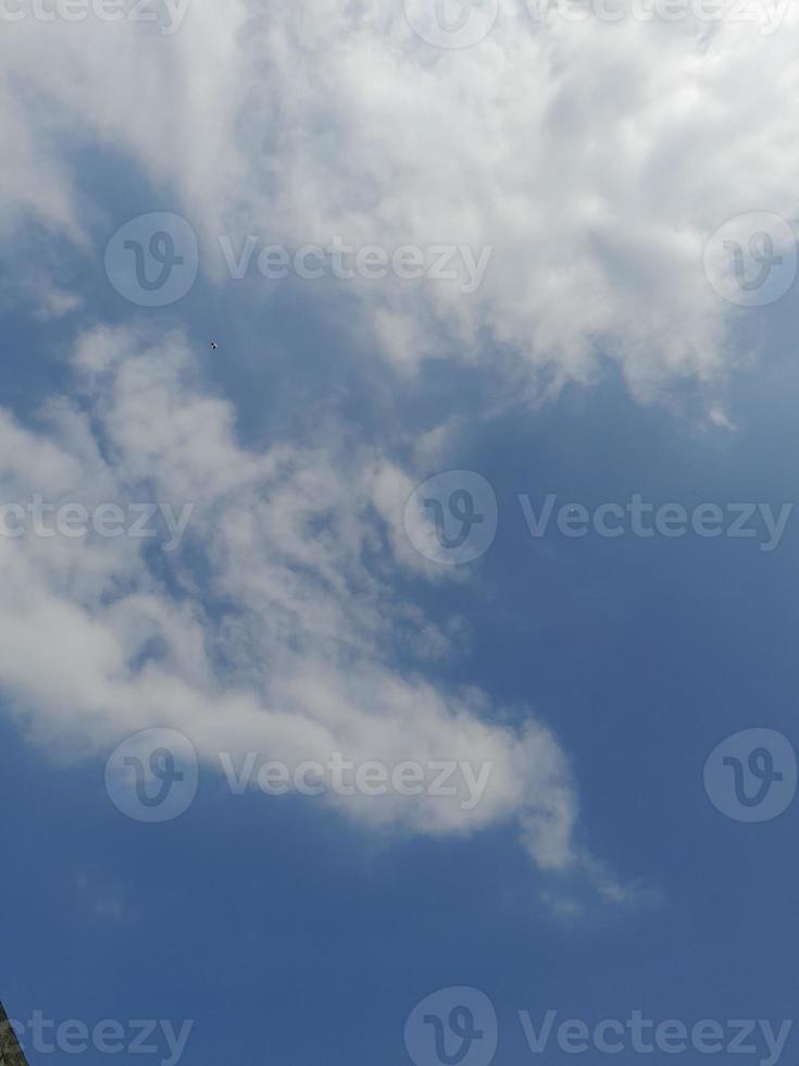 Beautiful white clouds on deep blue sky background. Large bright soft fluffy clouds are cover the entire blue sky. photo