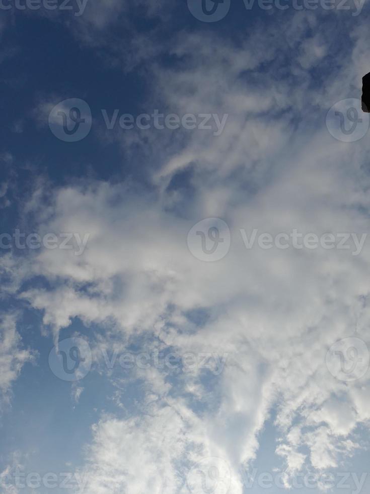 Beautiful white clouds on deep blue sky background. Large bright soft fluffy clouds are cover the entire blue sky. photo