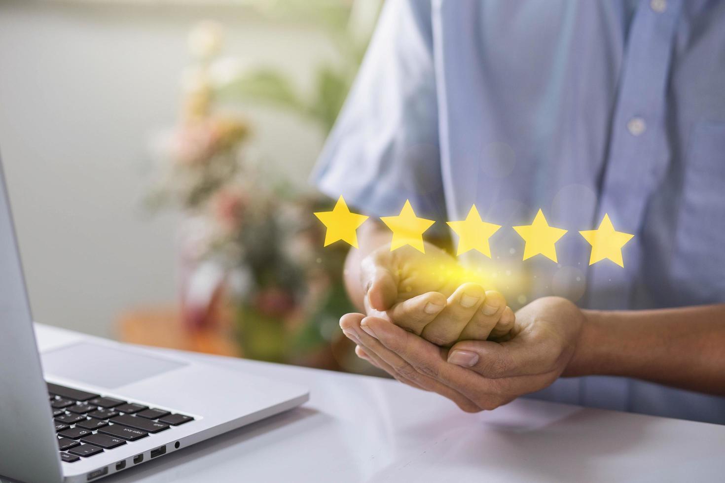 Man hand with popup five star icon for feedback review satisfaction service, Customer services best excellent business rating experience online. best quality product and service. photo