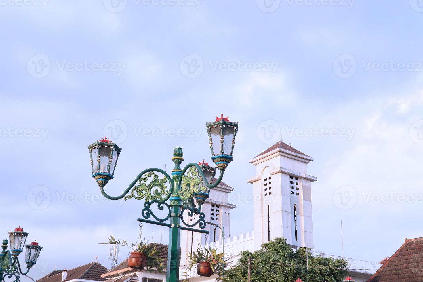 Vintage city lamp with blue sky view and clouds photo