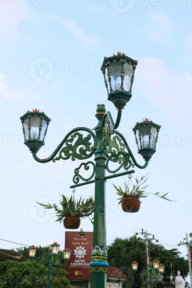 Vintage city lamp with blue sky view and clouds photo