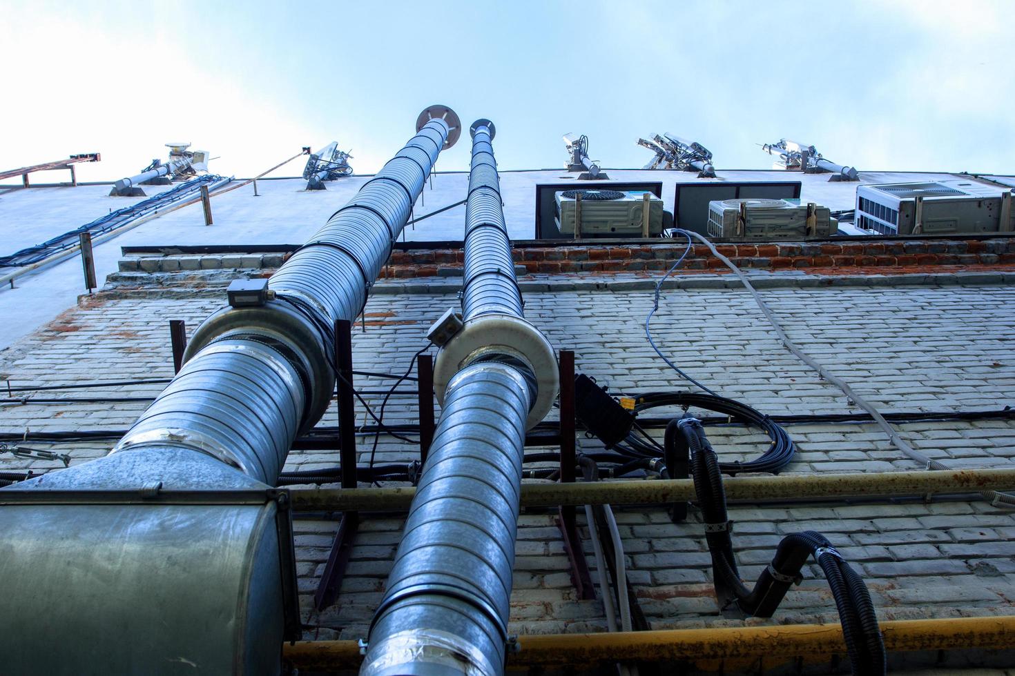 Large metal pipes on the wall the house. photo