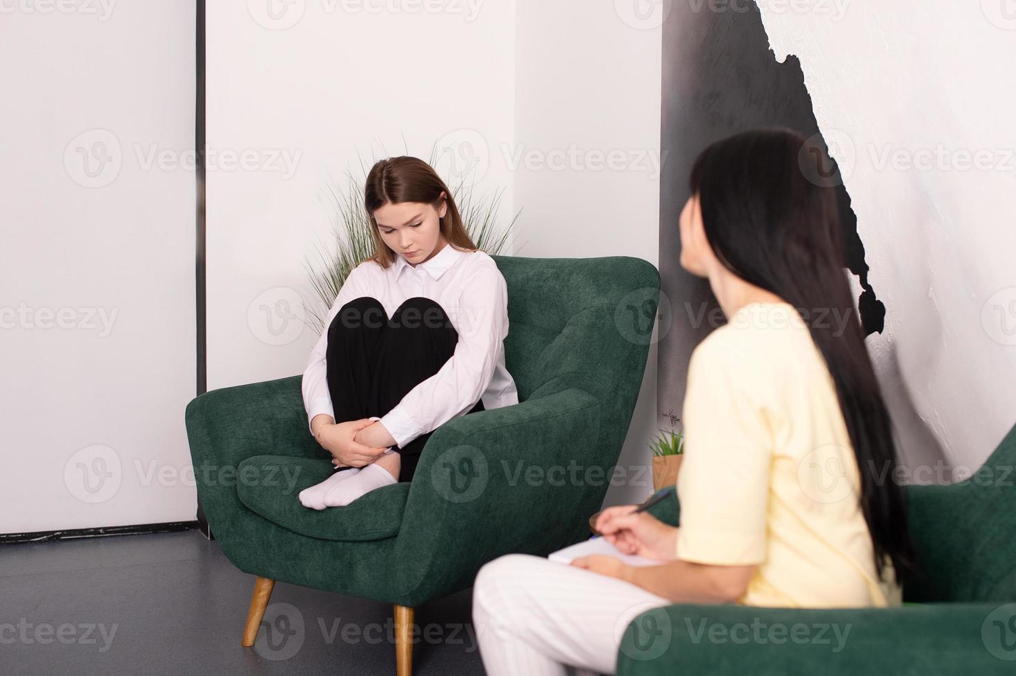 A psychologist helps a girl with emotional experiences photo