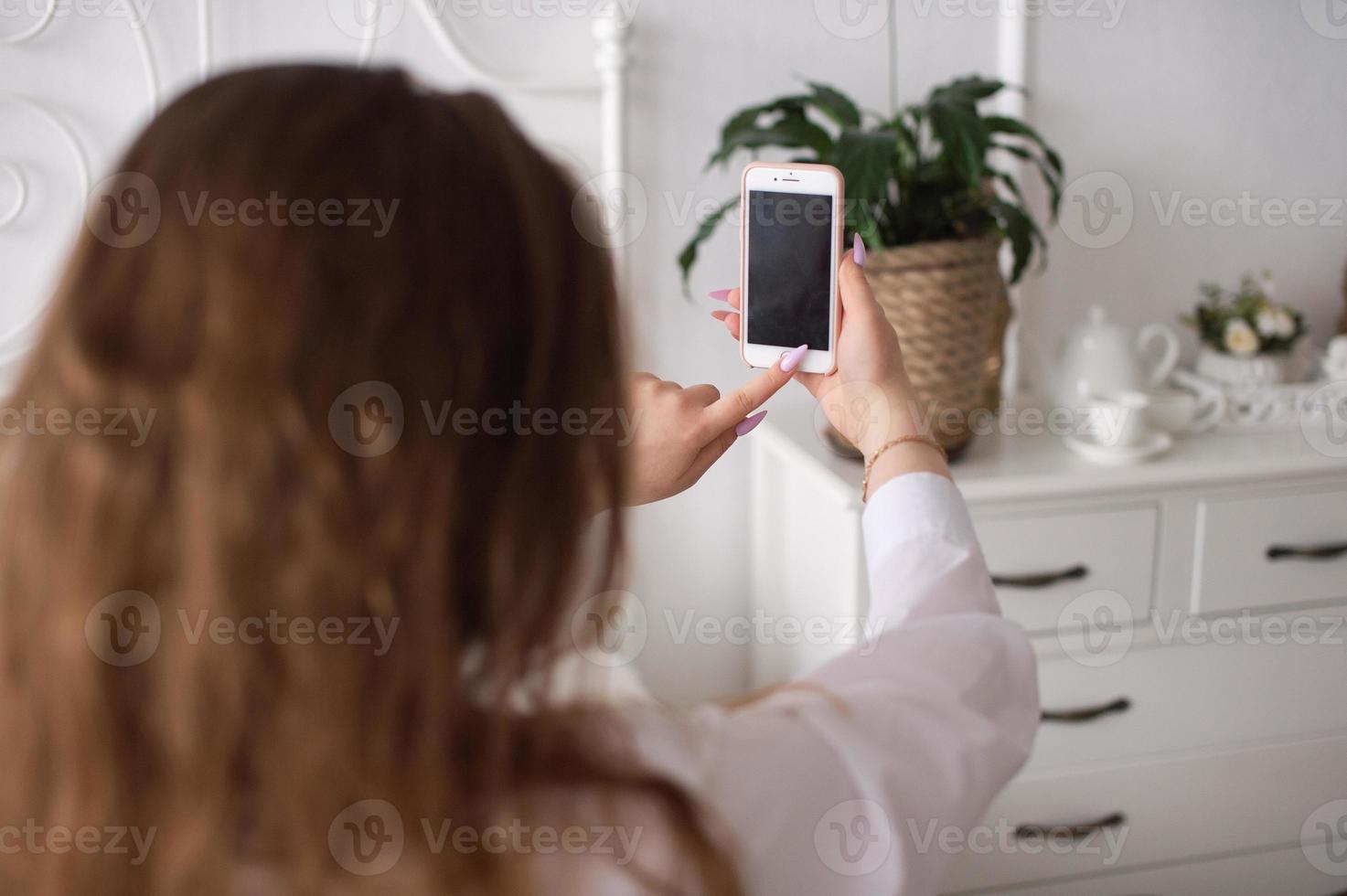 A young emotional woman presses the phone button. Without a face photo