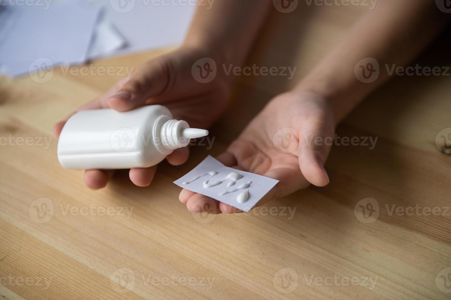 The boy cuts out details from paper. Glue the parts together with glue photo