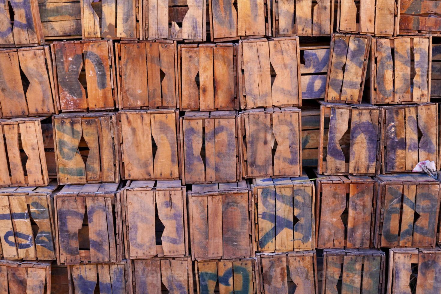 Pile of old numbered wooden crates photo