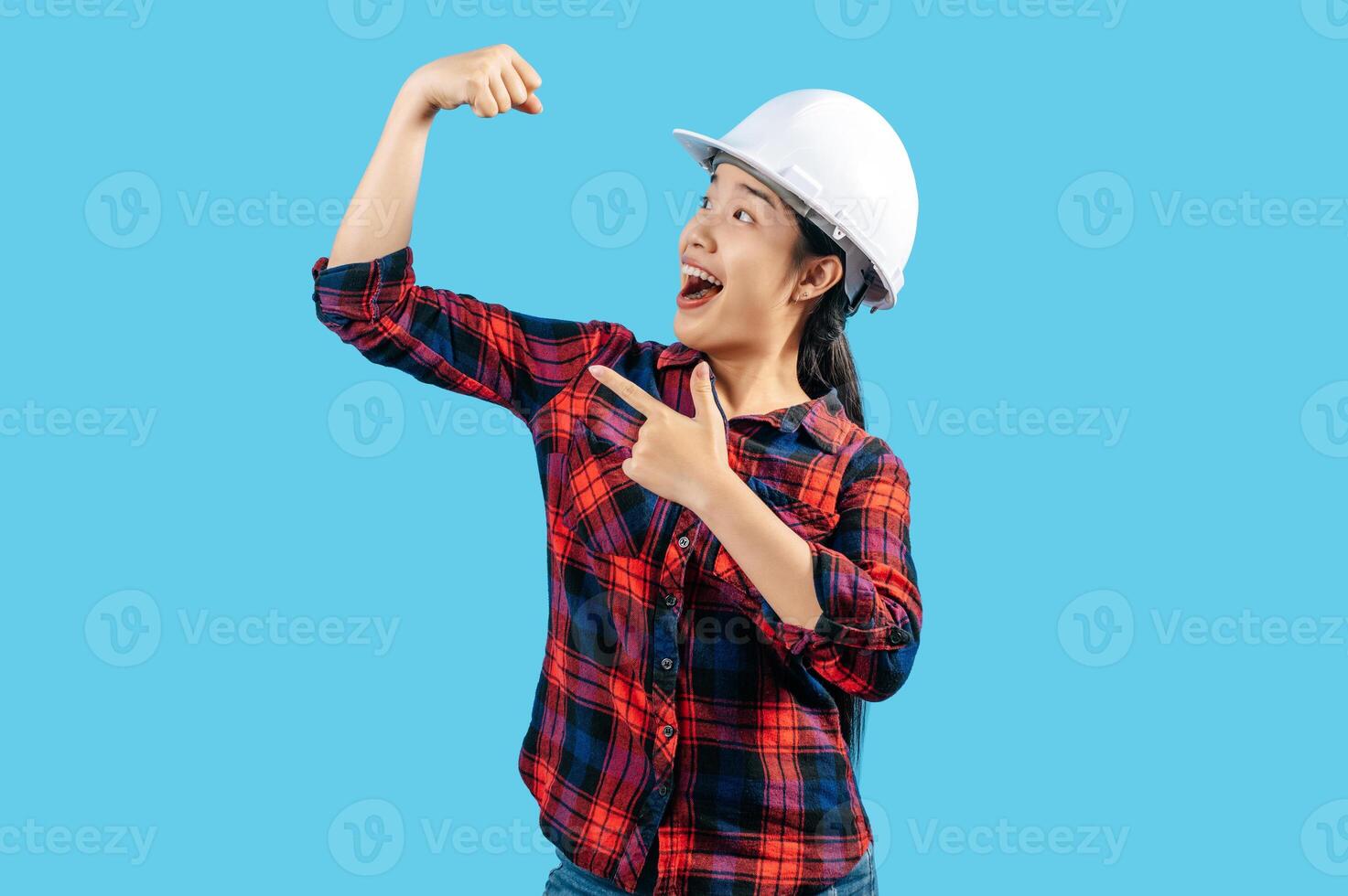 Young asian engineer female wearing helmet raise hand with good health photo