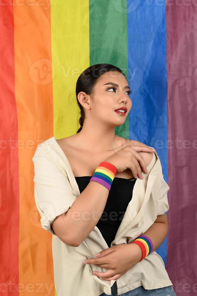 Pretty woman LGBQ pose with muli-color flag photo