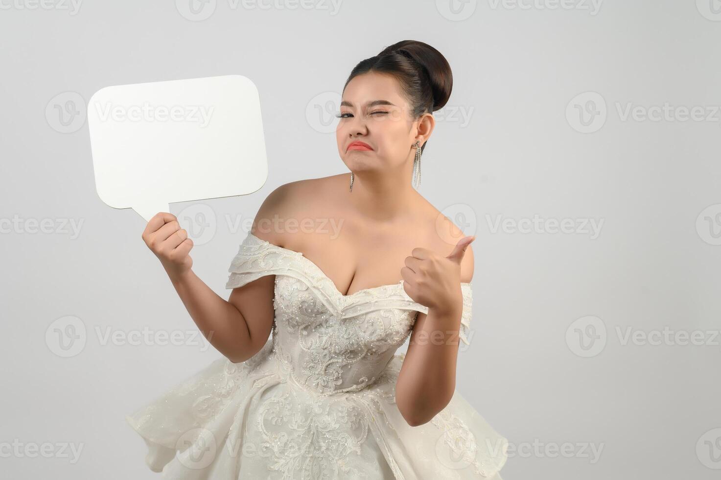 Young asian beautiful bride pose with mockup banner in hand photo