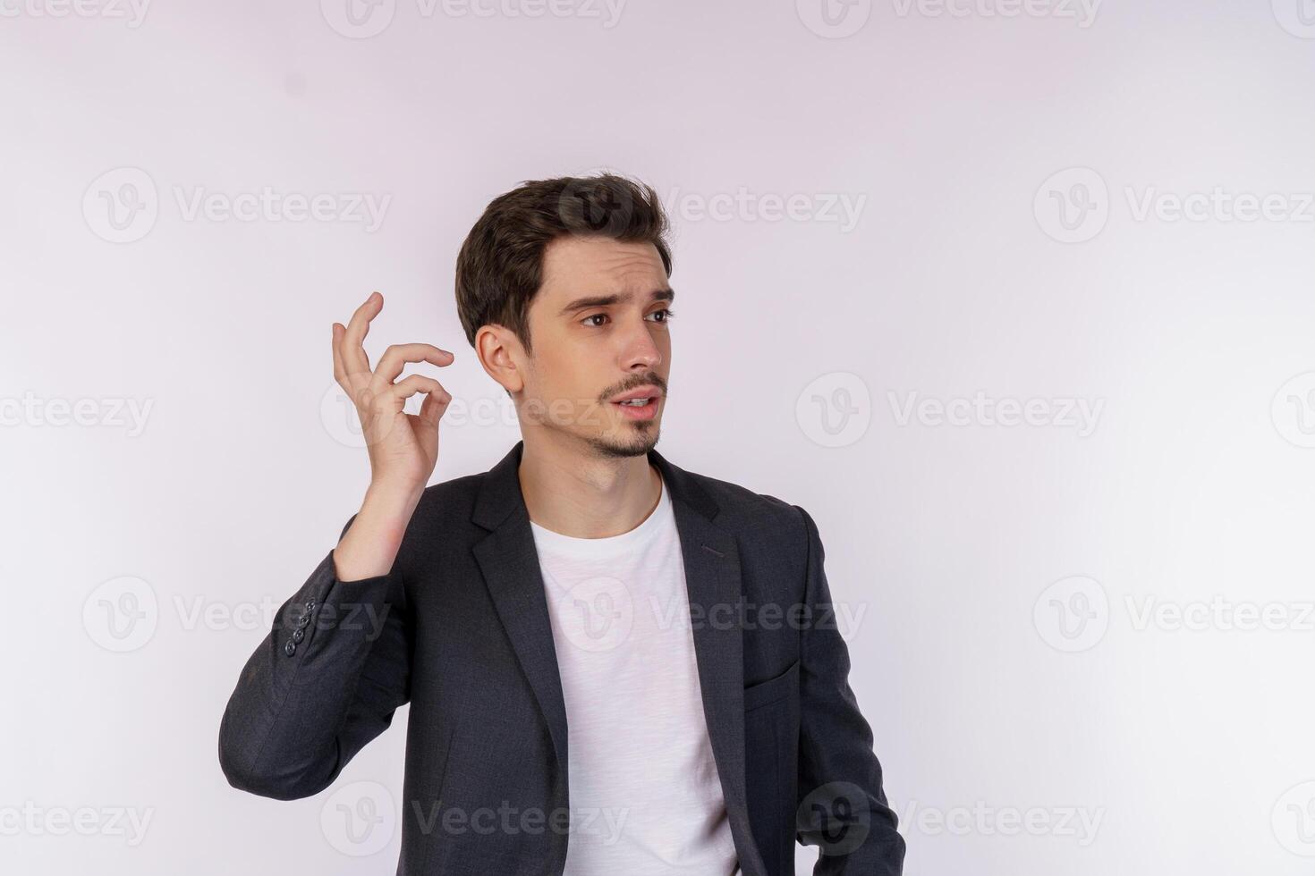 Portrait of thinking man surrounded by question mark on isolated background photo