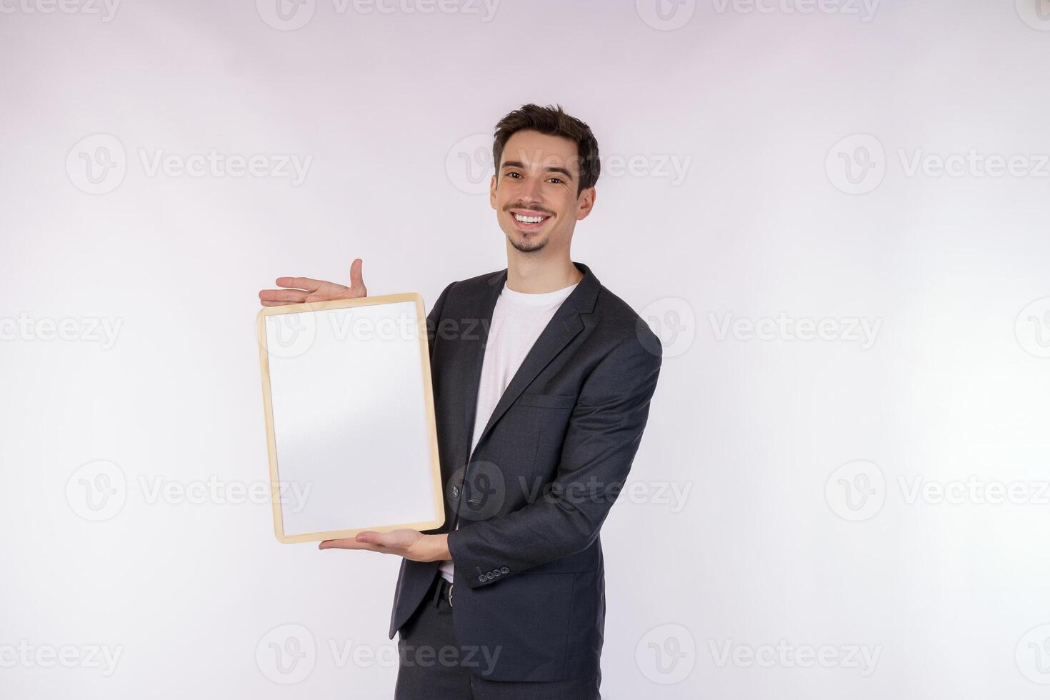 Portrait of happy businessman showing blank signboard on isolated white background photo