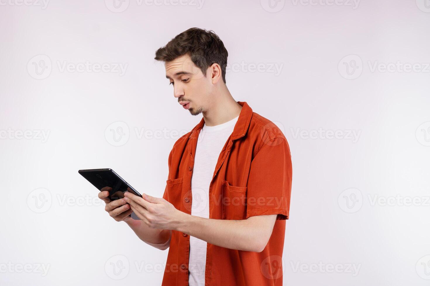 Portrait of attractive cheerful man using device app searching web isolated over white color background photo