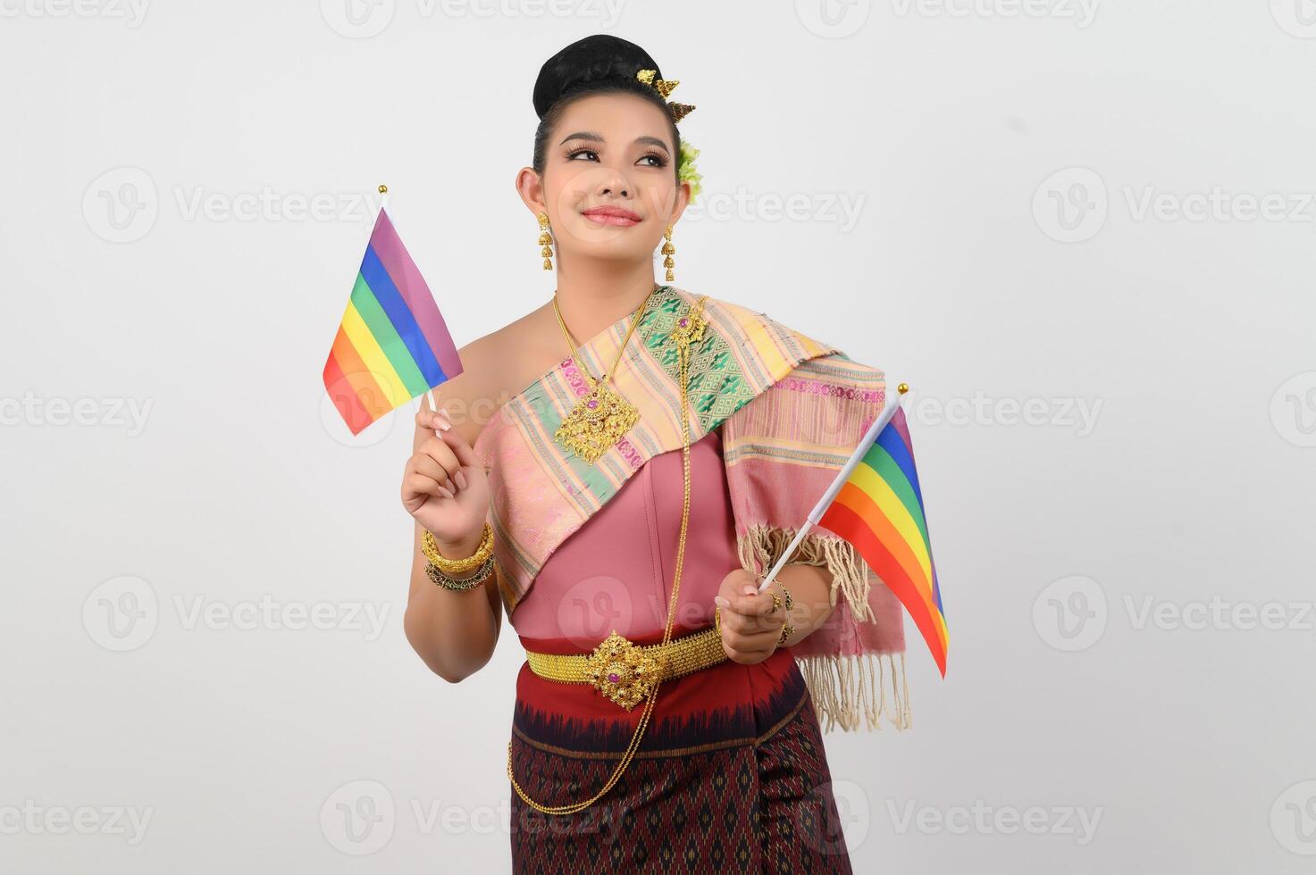 Portrait of Young woman in Thai Northeastern Traditional Clothing holding rainbow flag photo