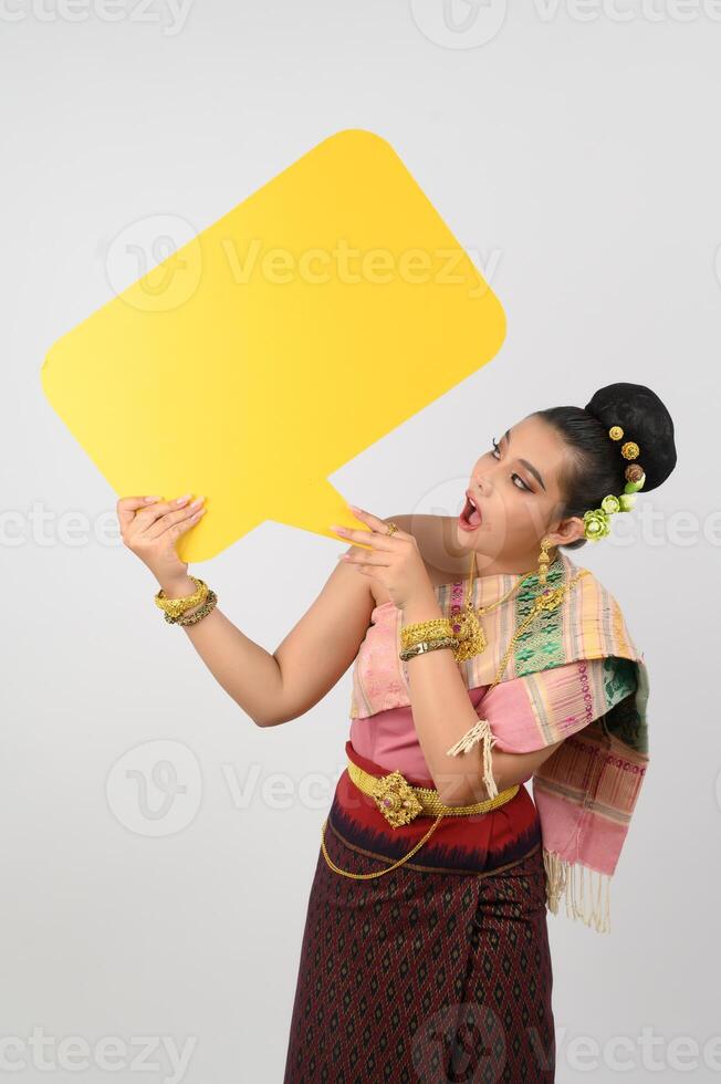 Young beautiful woman in Thai lanna costume with blank speech bubble sign photo