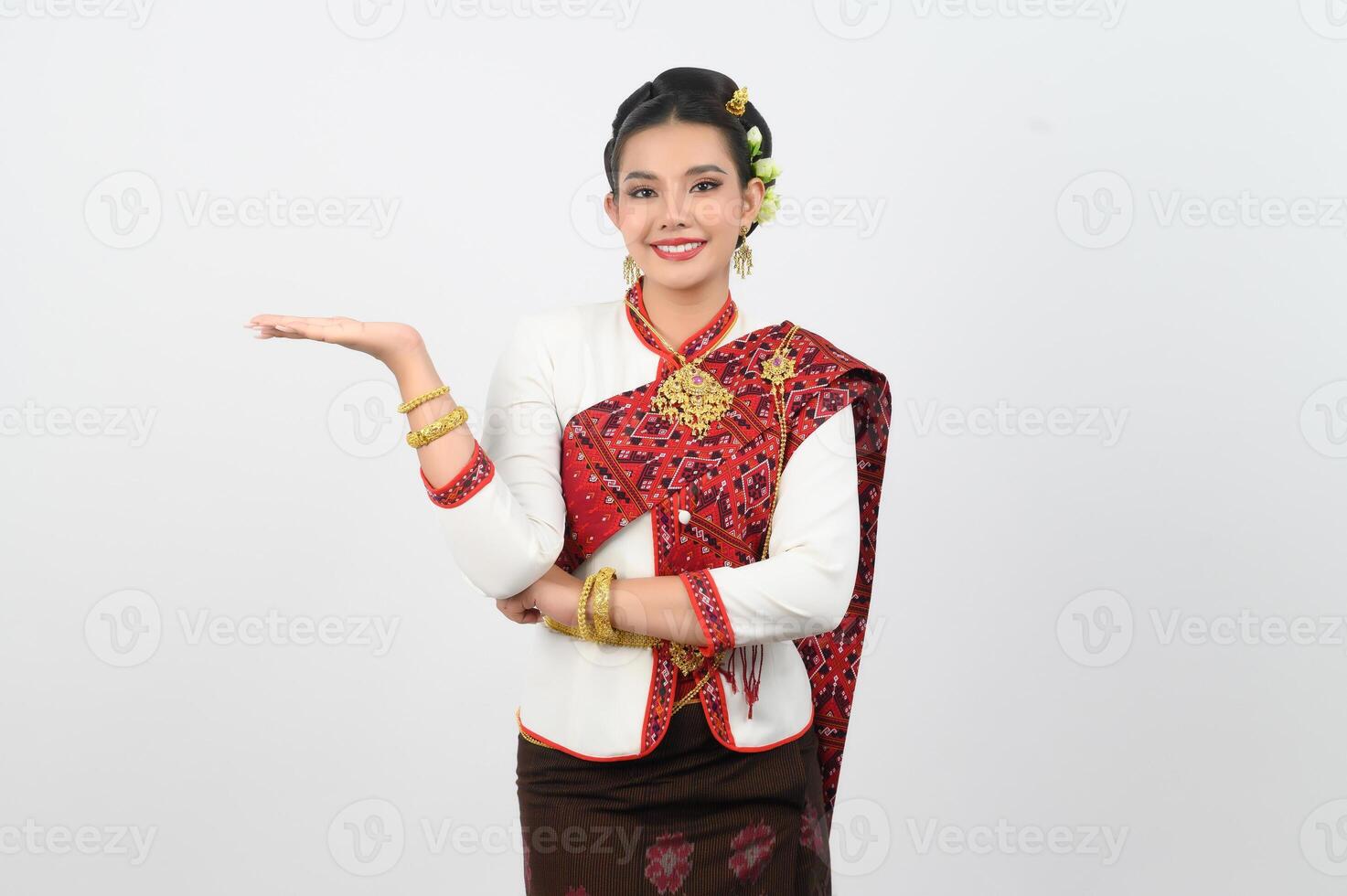 Young beautiful woman in northeastern dress stand and open palm posture photo