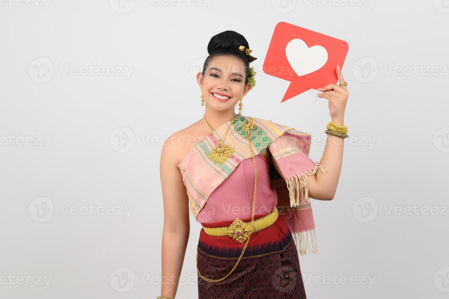 Young beautiful woman in Thai northeastern costume with card in heart symbol photo