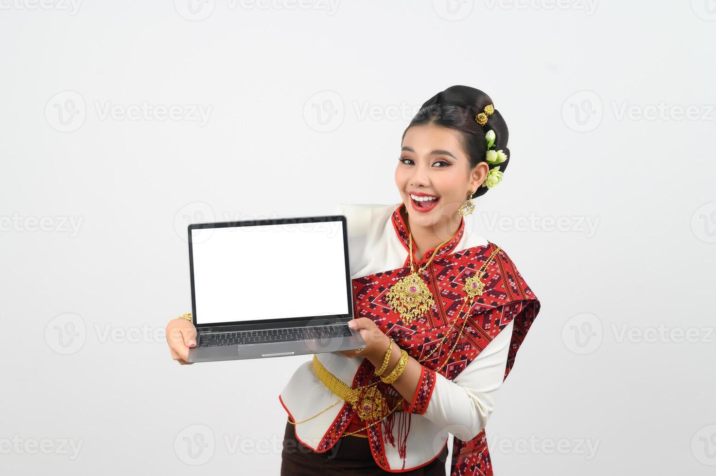 retrato de hermosa tailandés mujer en tradicional ropa posando con ordenador portátil computadora foto